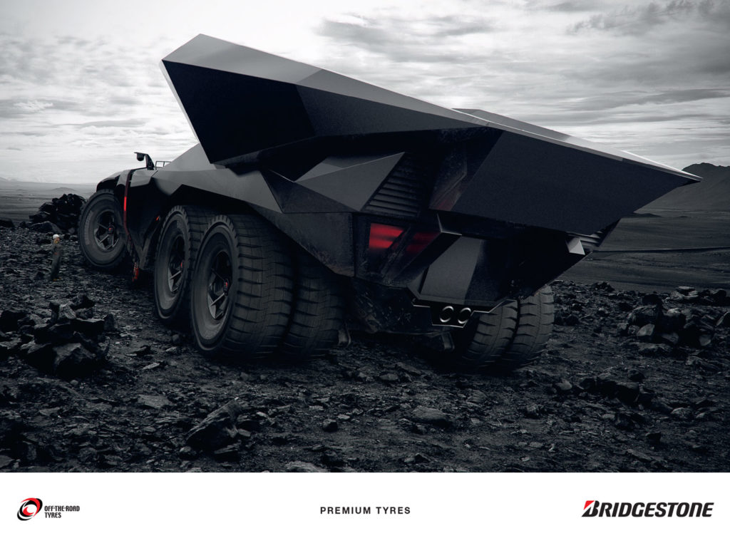 Hybrid car with huge premium tyres moving stones