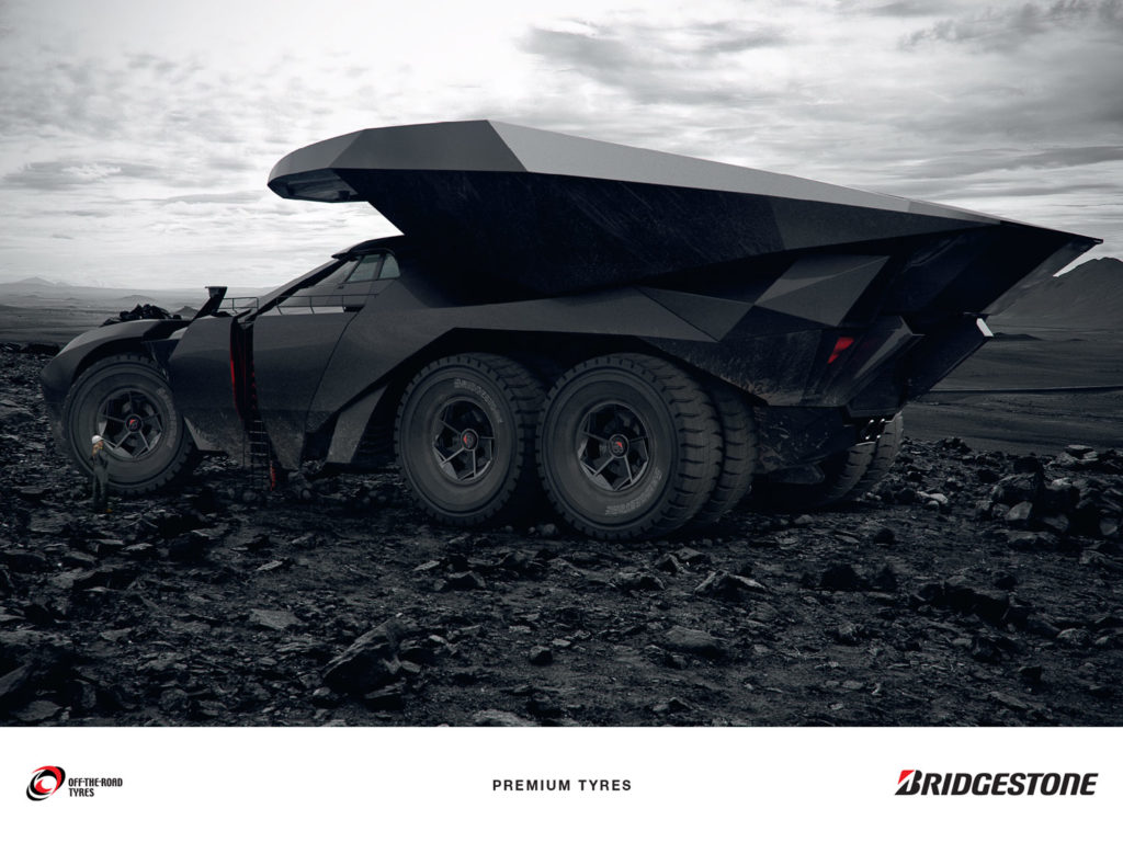 Hybrid car with huge premium tyres moving stones