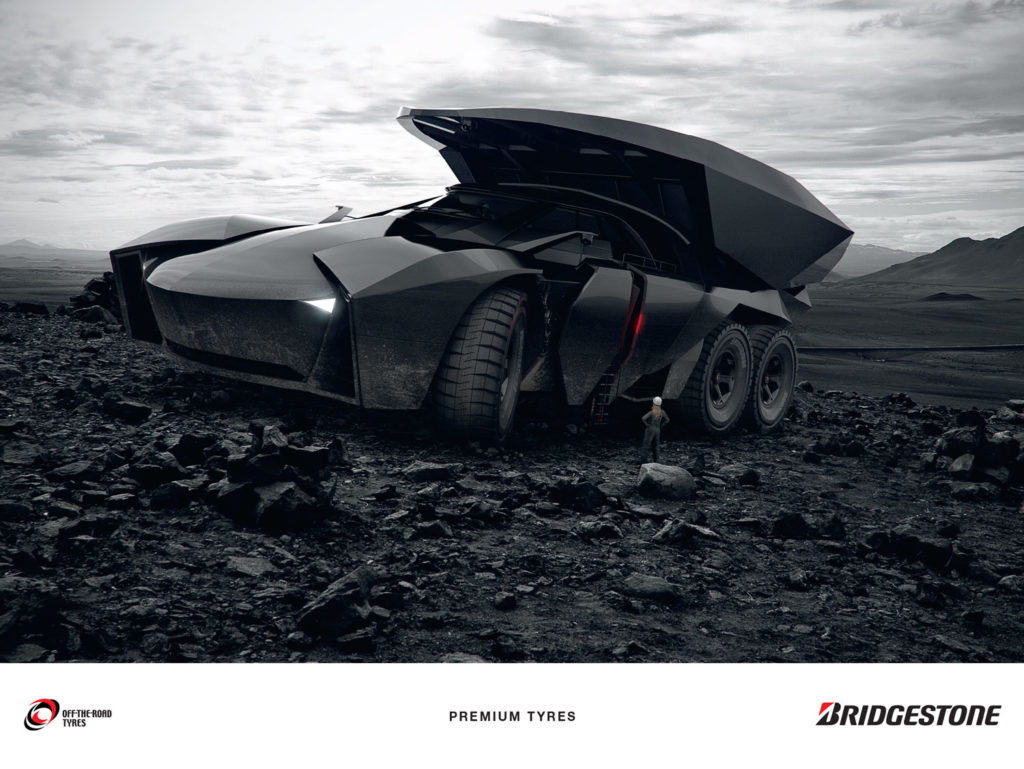Hybrid car with huge premium tyres moving stones