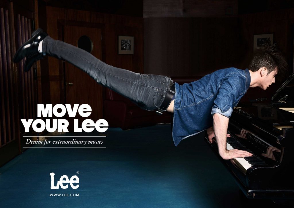 Young man playing the piano in a lee jeans outfit