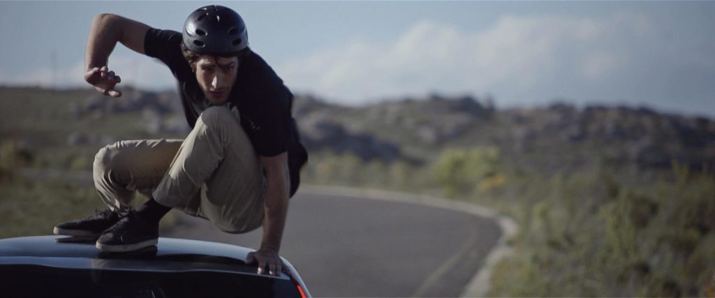 Decio Lourenco doing longboarding on a Peugeot 208