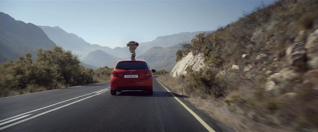 Decio Lourenco doing longboarding on a Peugeot 208